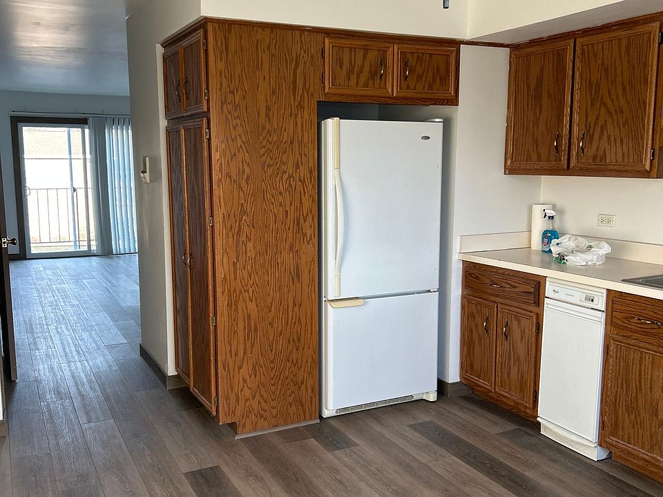 standing in your kitchen looking back into the family room out to the balcony.