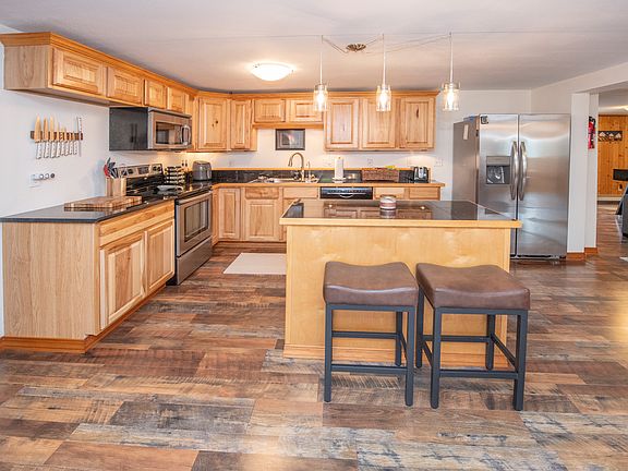 Open concept kitchen that allows for visiting with the whole family from kitchen to dining room to living room. Huge fridge, island with seating, plenty of prep space and all the appliances needed for a great meal. Place settings for at least 10.