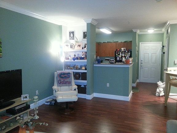 Living room with view of kitchen and front door.