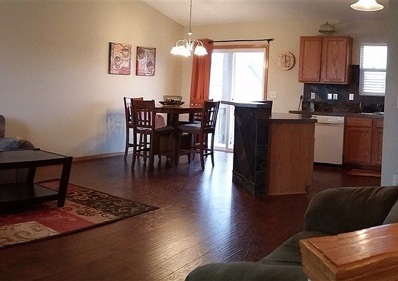 The living room, dining room and kitchen are part of the wonderful open floor plan. With new wood la