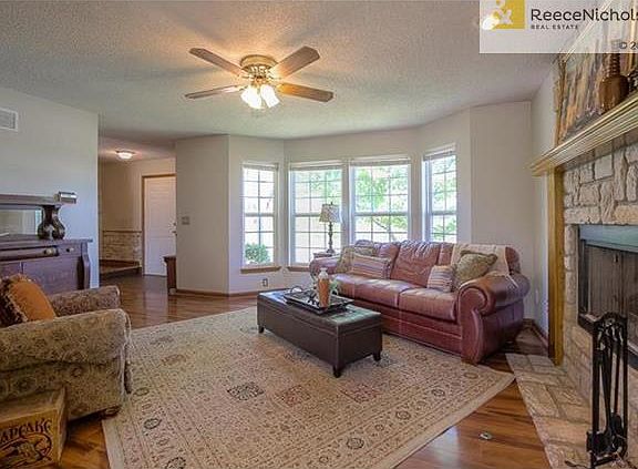 Fireplace and ceiling fan in living room.