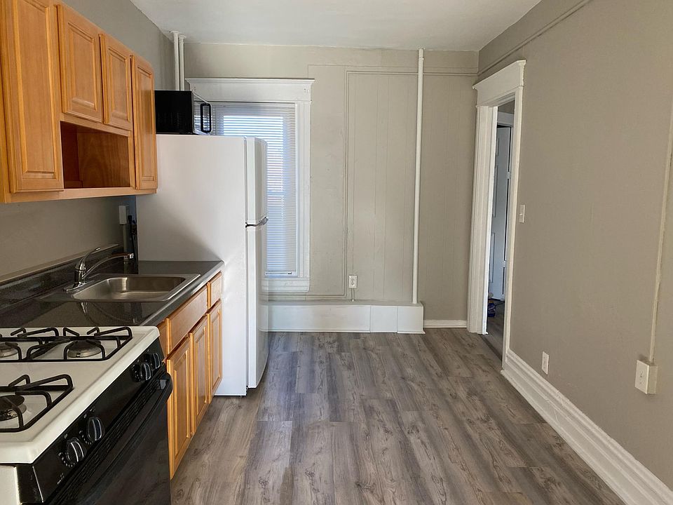 Kitchen - with new flooring, cabinets, sink, and refrigerator; also has washer/dryer hookup and microwave