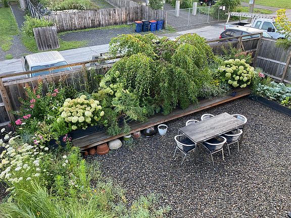 Entrance to the apartment through the garden. Off street parking behind garden fence.