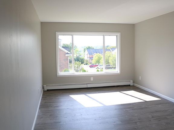 Large windows in the living room let in lots of natural light.