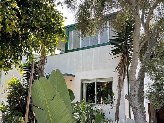 View of the building with the enclosed portion (windows open) of the deck visible