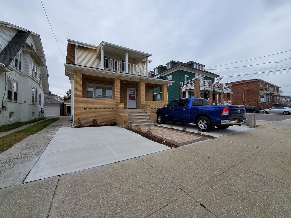 Front of house. Truck in in parking space.