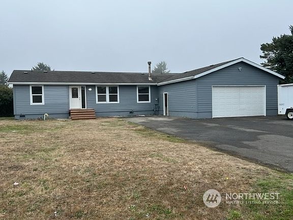 Street view with large paved double driveway & double car garage.>