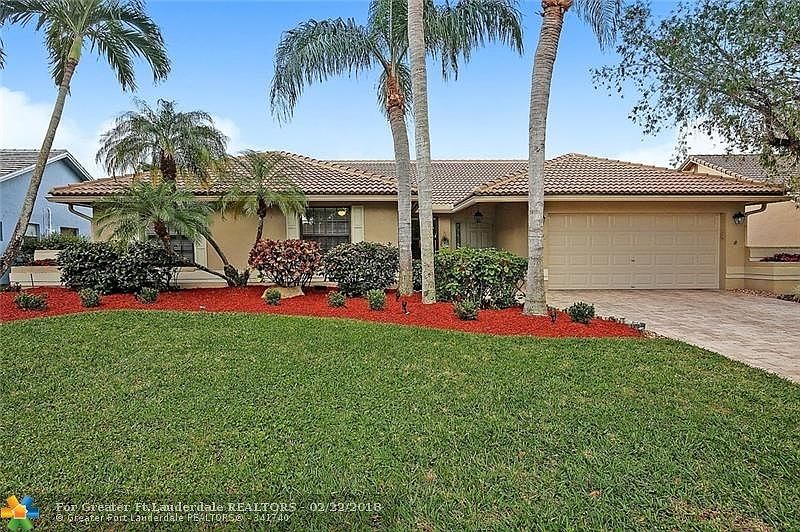 Fresh, clean curb appeal from the pavers to the palms.