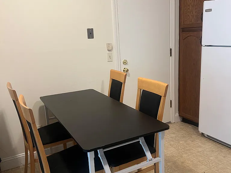 Eat-in dining nook with a table for four, set next to the kitchen for easy meals and everyday use with second entrance.