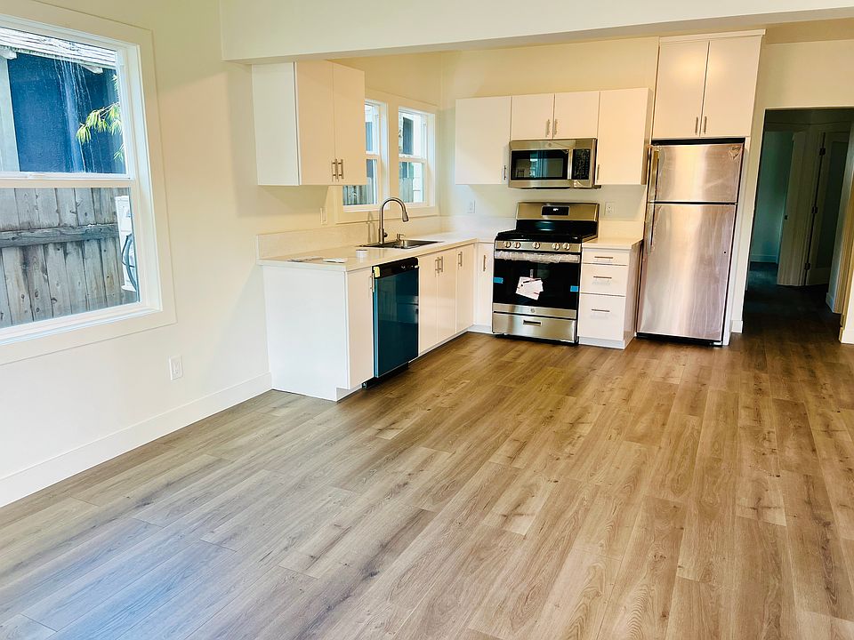 Lower unit kitchen and living room featuring all brand new stainless steel appliances.