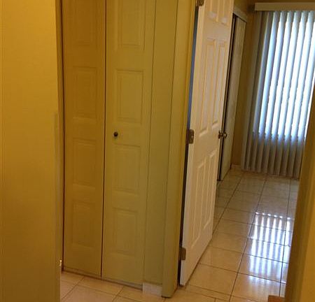 Hallway between bedrooms and bathroom; linen closet