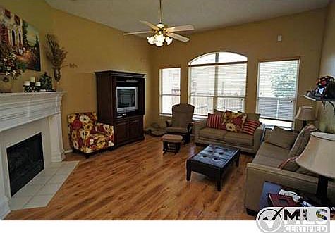 Family room features corner fireplace, laminate-wood floors, and