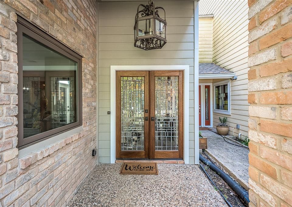 Spectacular leaded glass double doors greet you upon entering this stellar town home. Wrapped in brick and hardi plank with a new roof and HVAC (2019) and flanked by double paned windows throughout, you will be impressed with the high end finishes an