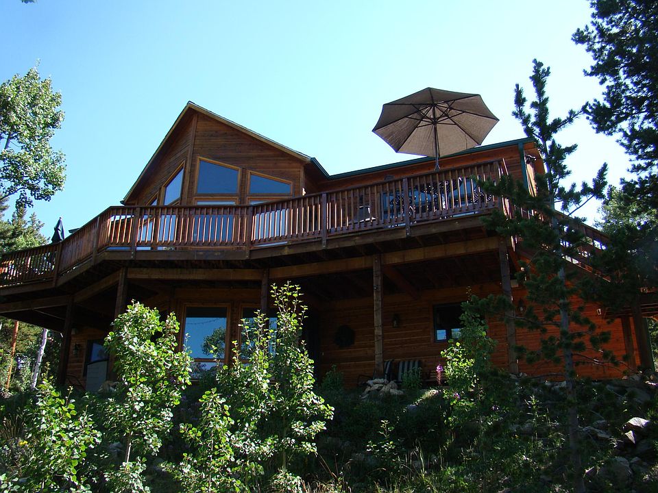 Beautiful custom home on 2 acres with views of three 14,000 ft. peaks. Front deck covers about 800 sq. ft. and overlooks a small lake below. Main level is a totally open concept.
