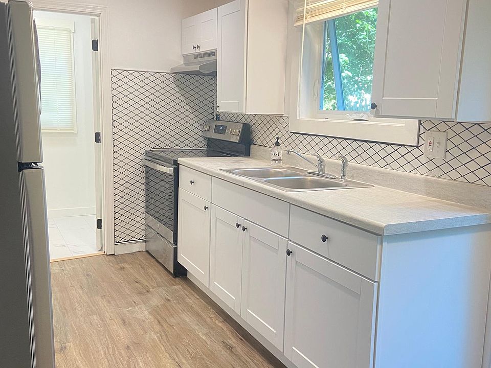 Newly renovated kitchen with new stove, new refrigerator and new cabinets.