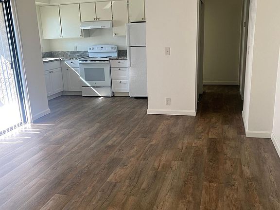 hall way leads to bedrooms, bathrooms