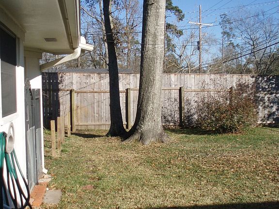 Backyard also features two shady mature trees.