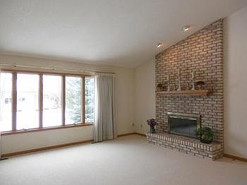 Large formal living room offers a great brick fireplace