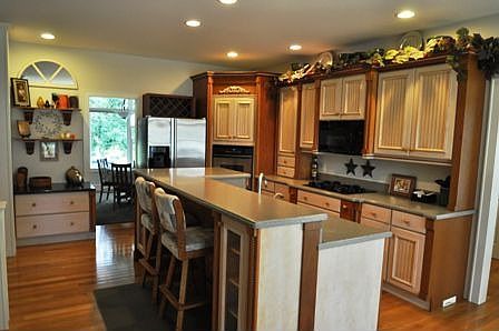 Kitchen has cherry and maple glazed cabinets