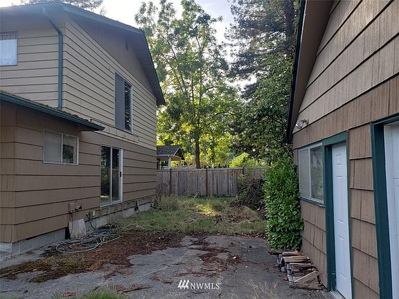 Looking at back of house and front of detached garage