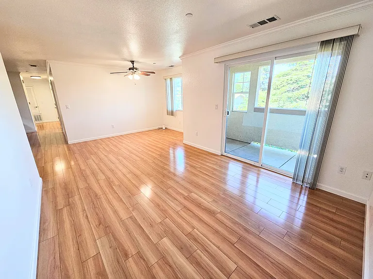 From the far wall showing the dining area and balcony, hallway for Unit 40