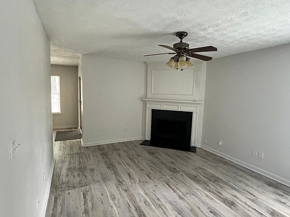 Spacious living room with a gas fireplace and fan