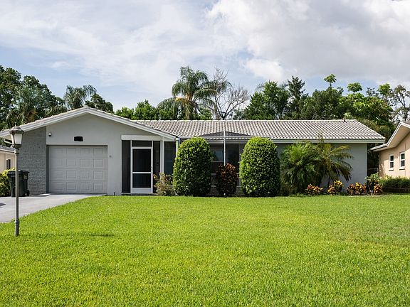 Exterior of the home with a large front yard.