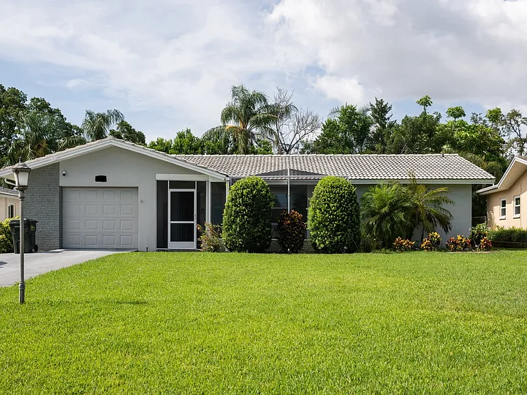 Exterior of the home with a large front yard.