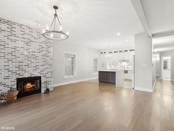 The front living space is an open floor plan with an over sized, sit-at island with plenty of room for a dining table.