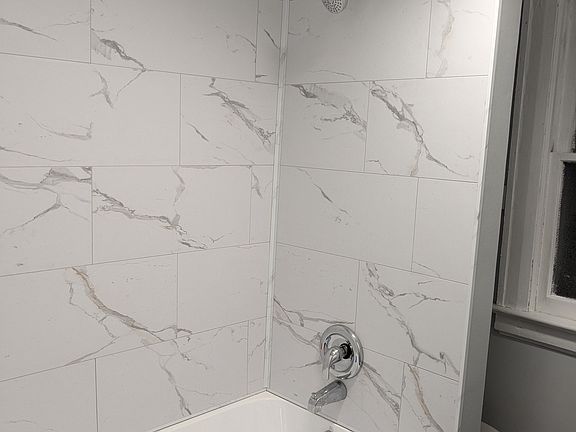 Lovely tub surround. Shower bar to be added.