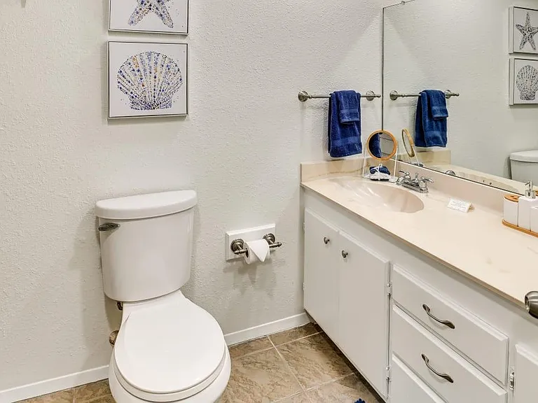 Hallway Full bathroom with walk in shower and 2 sinks.