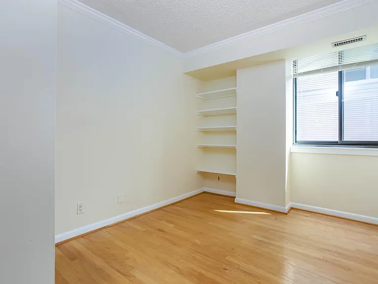 2nd bedroom with built-ins and window