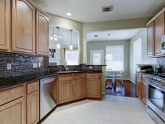 Lovely stainless steel appliances and updated backsplash are highlights in this spacious kitchen