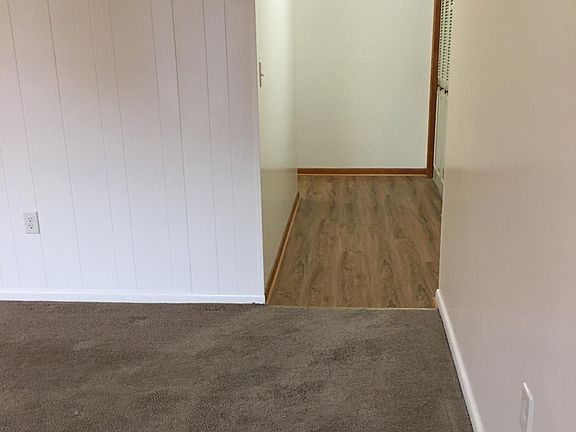 This hallway has new flooring and leads to the bedrooms.
