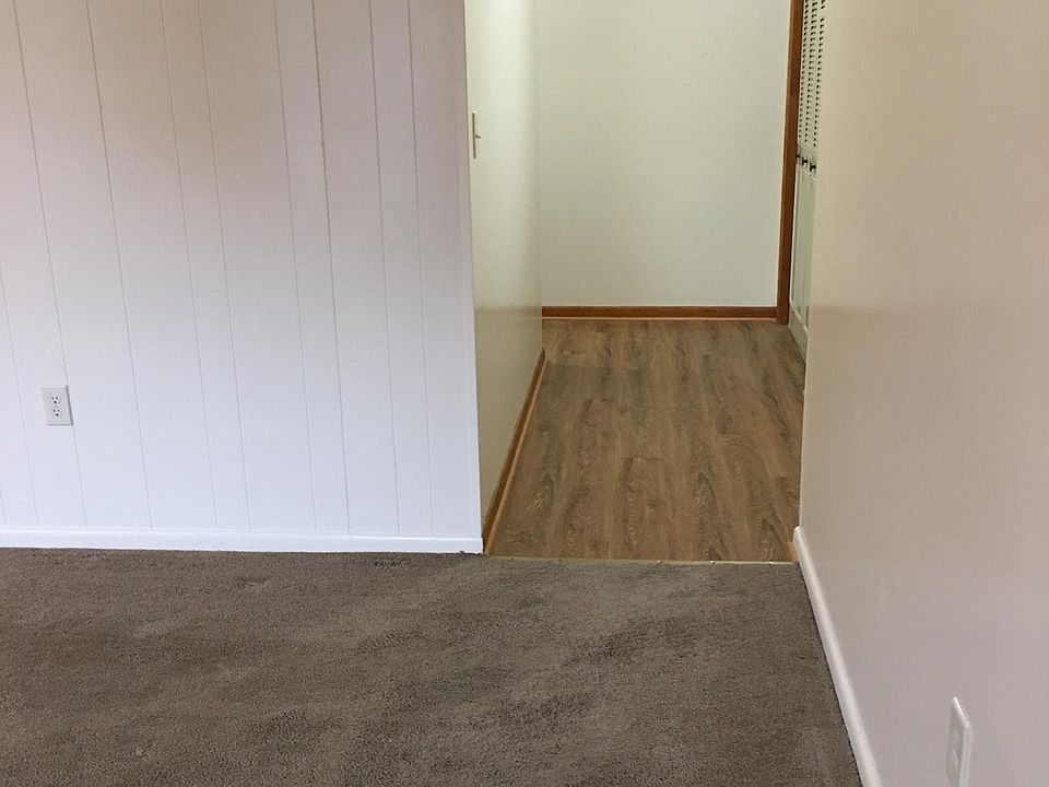 This hallway has new flooring and leads to the bedrooms.