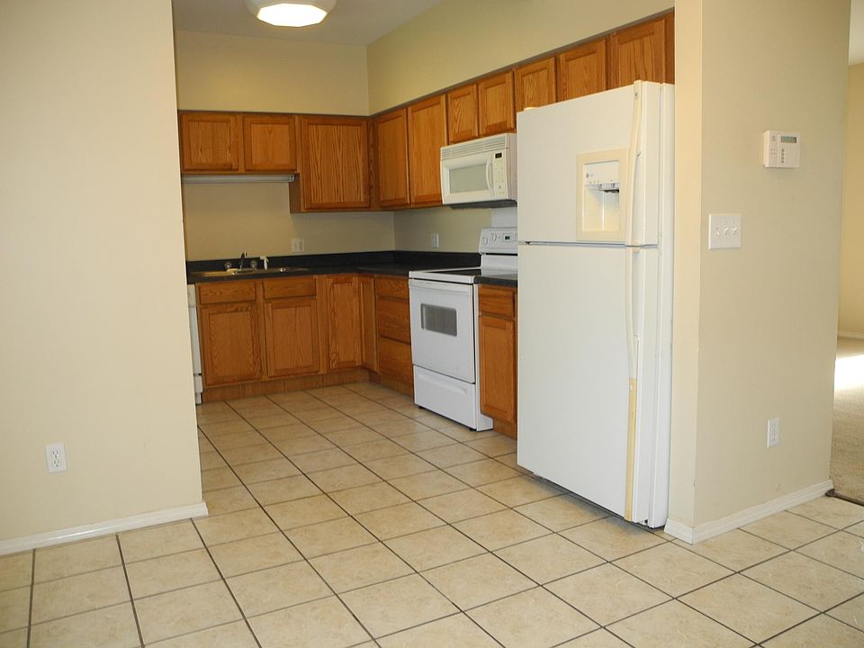Tiled Kitchen with Deluxe Refrigerator and over the range mi