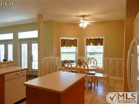 Eating area features bay window alcove overlooking the back porch and pool area.