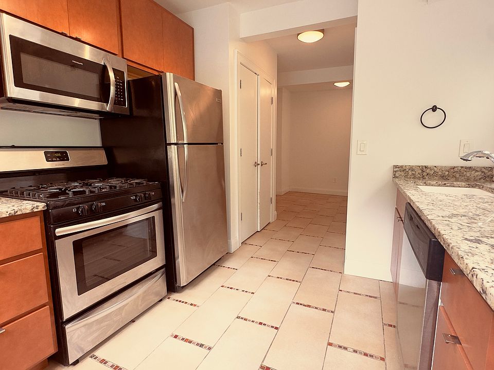 Kitchen with Stainless Steel Appliances and Modern Light Fixture
