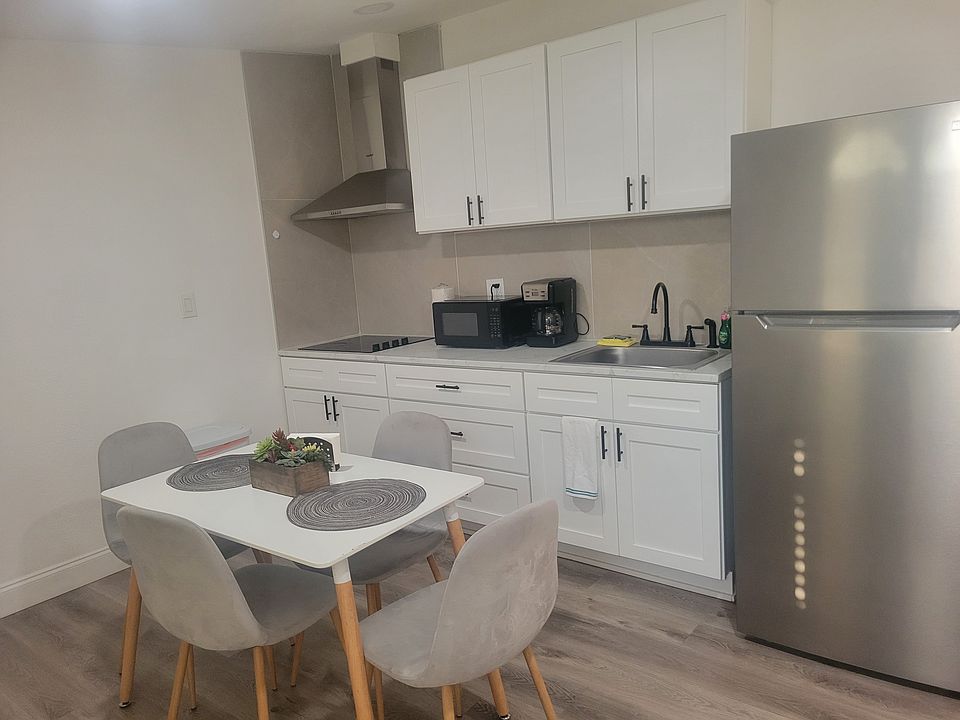charming dining room and kitchen with refrigerator and essential amenities