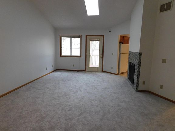 Spacious living room with gas fireplace, access to deck, vaulted ceilings and skylight!