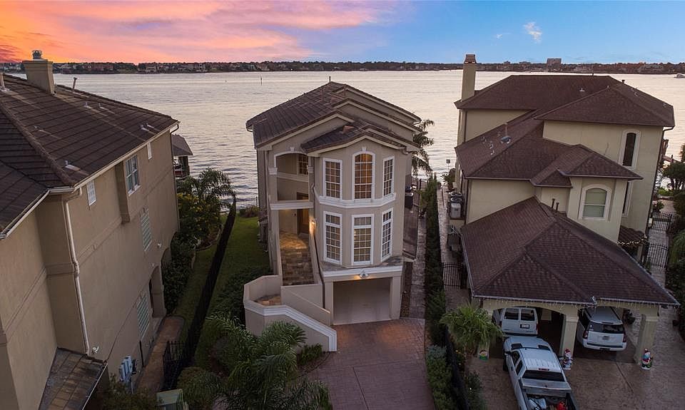 MUST SEE VIEWS FROM EVERY ANGLE AT THIS INCREDIBLE LAKEFRONT HOME IN SEABROOK. A NORTH/SOUTH ANGLE ALLOWS FOR VIEWS OF BOTH SUNRISES AND SUNSETS WHILE PATIOS AND BALCONIES ON EACH LEVEL ALLOW FOR SOME OF THE BEST VIEWS OF CLEAR LAKE POSSIBLE.
