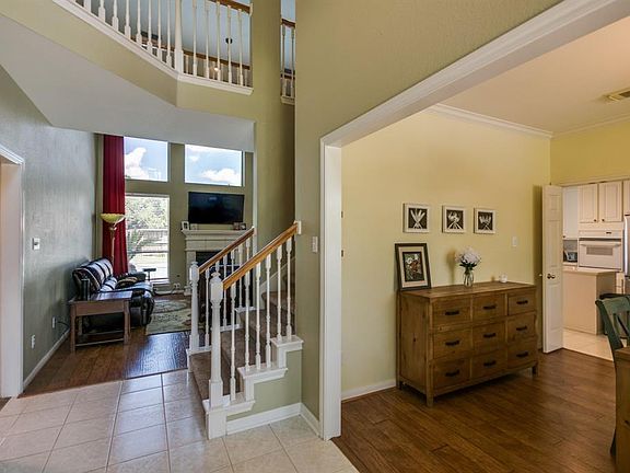 Solid flooring continues throughout the foyer, dining and living room of the home.