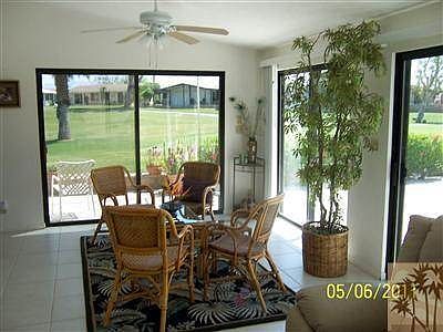 North end of sunroom. Windows surround entire sunroom and automatic outside rolling shutters are on 