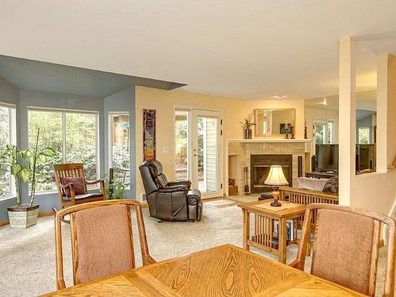 Living room and dining area has open floor plan with a view of the gardens.