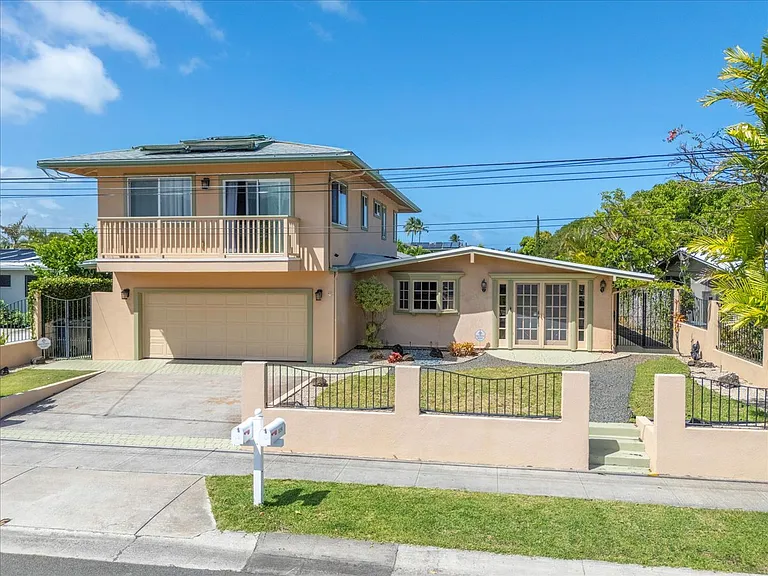 Front view of property and second story apartment.