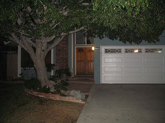 Front yard with part of 3 car garage