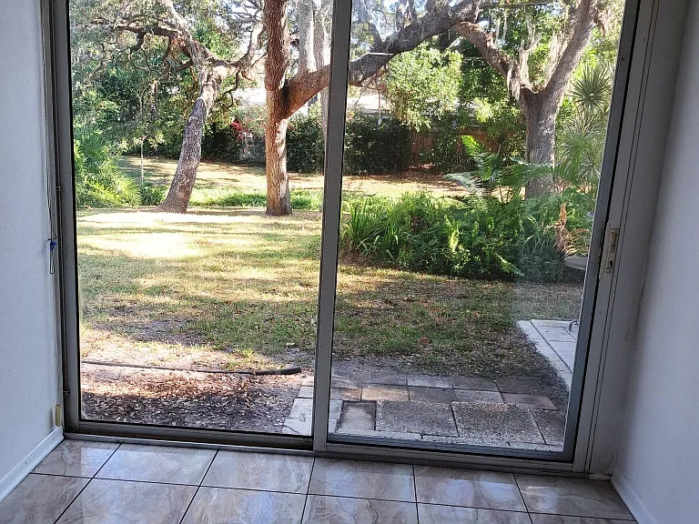 ENCLOSED PATIO WITH SLIDING DOORS OUTSIDE