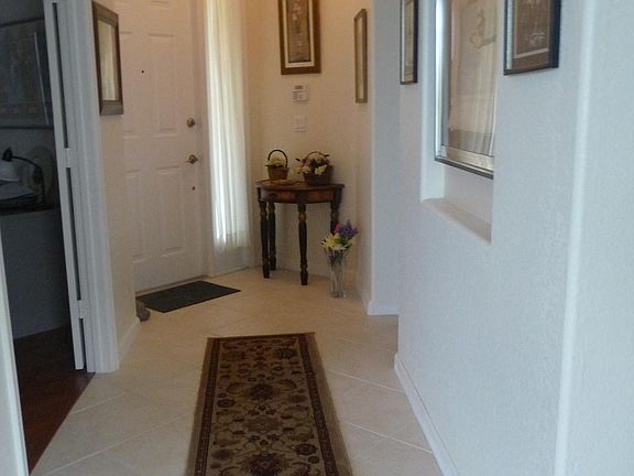 View from Dining Room of Entrance and Left is the Double Door Entry to Office. There is CLEAN White Tile at: Entrance, Bathrooms, Large Kitchen and Washer/Dryer/Storage Room.