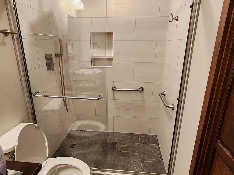 Property has 2 full size showers. Main Floor and Lower level Bathroom tile showers are identical with 12" rain head and built in stainless hand wand. Main level bath has overhead ceiling infra red warming lights. (not pictured)