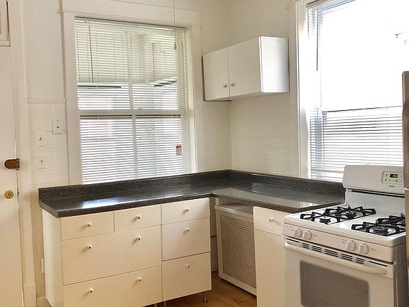 ceiling fans in four rooms.view from kitchen overlooks enclosed sun porch and beyond.light from north and east